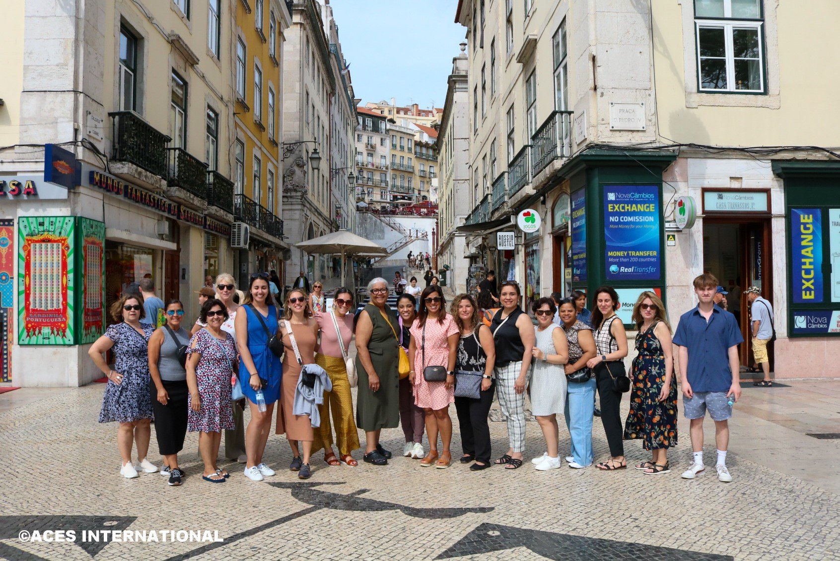 The Educators Field Study group takes a picture in front of several buildings in Portugal. 